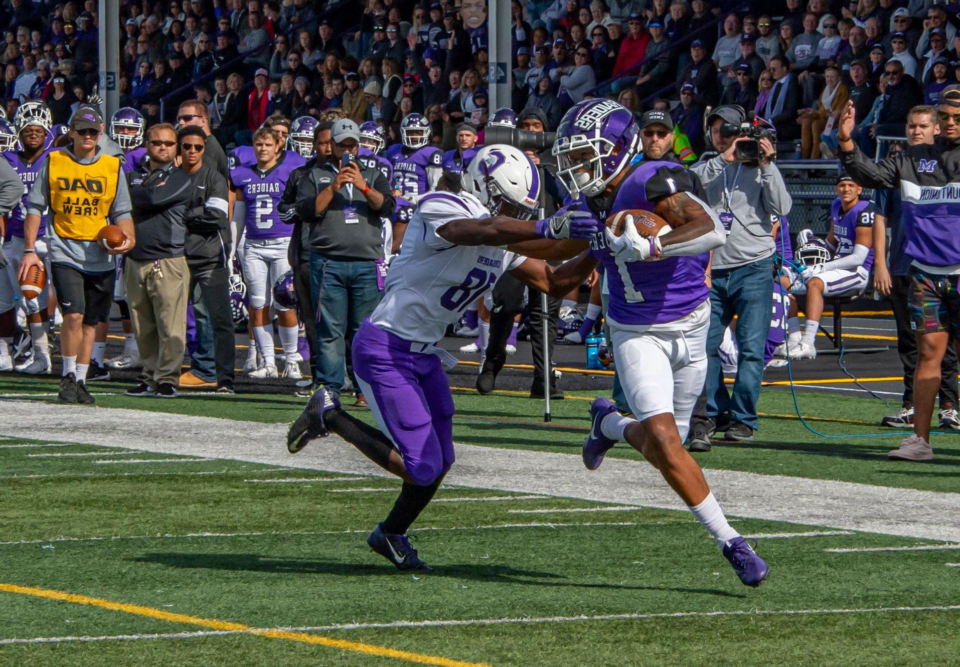 football player with stiff arm